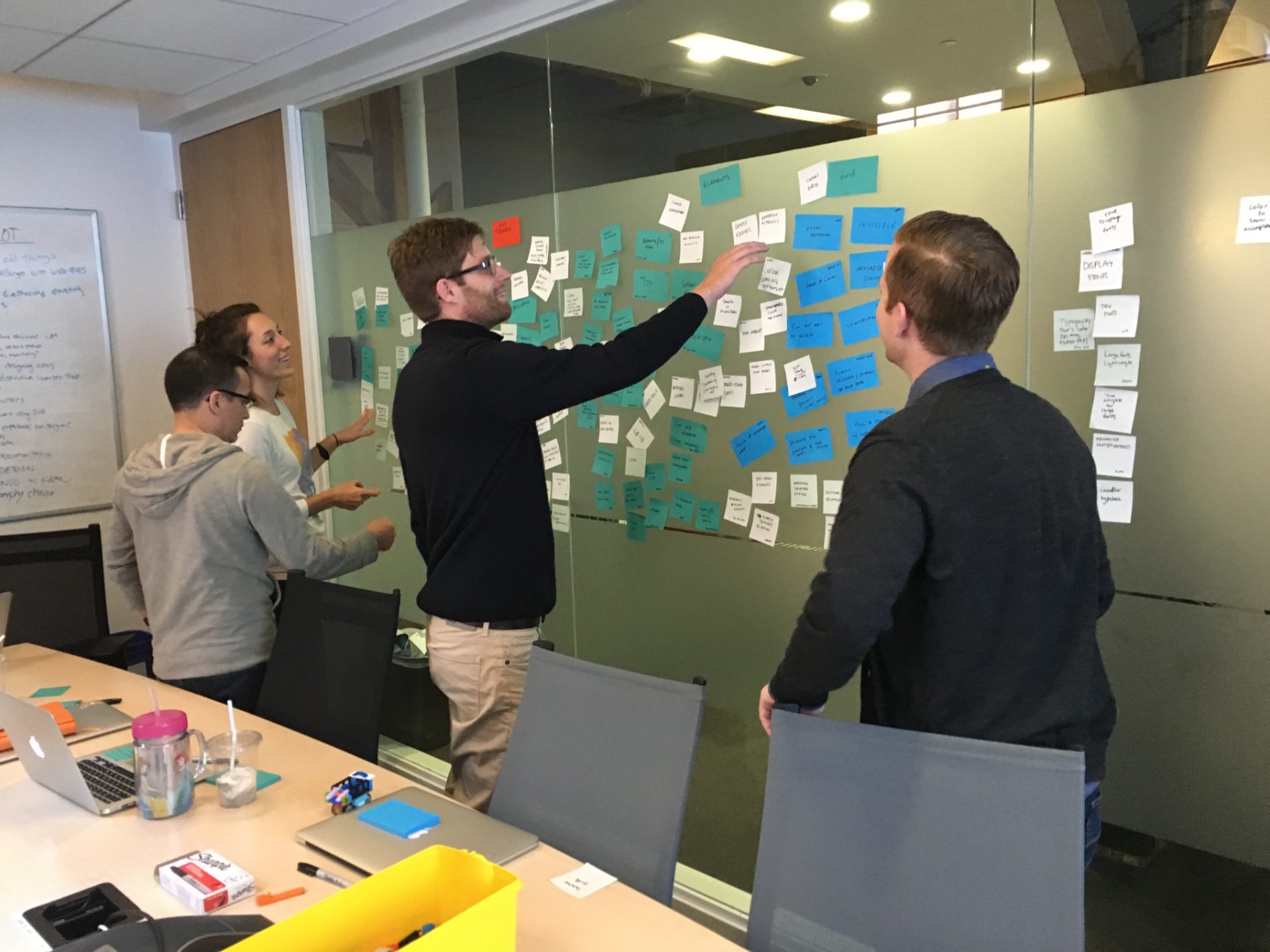 The design team mapping the system on a glass wall
